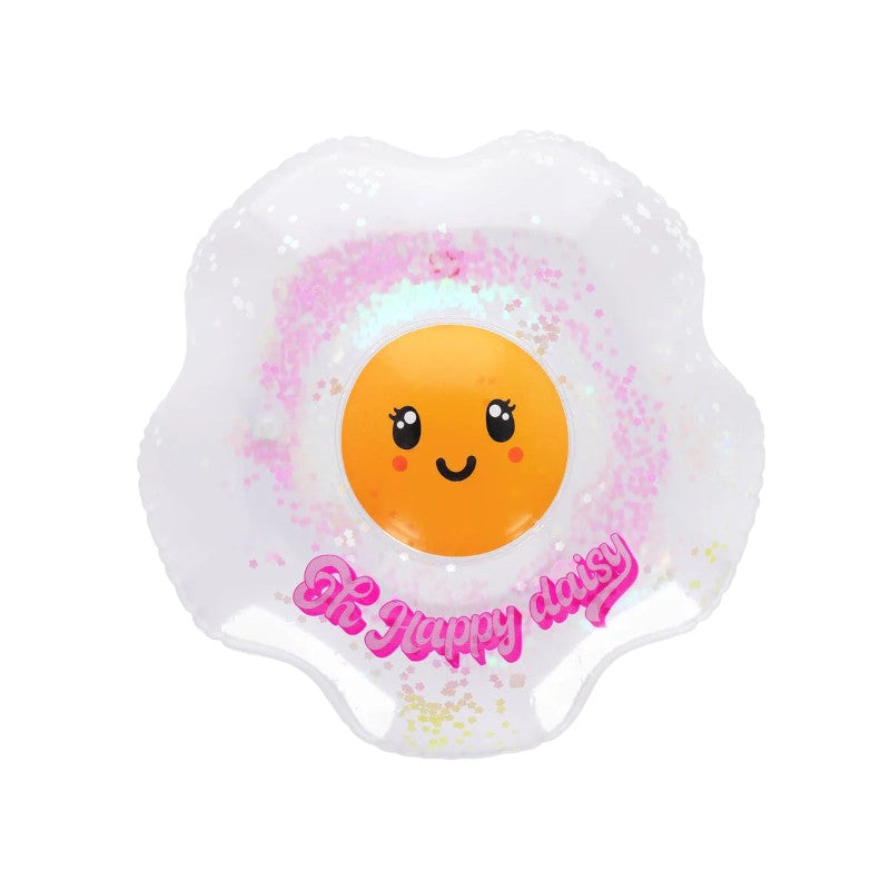 Cuscino gonfiabile Legami Oh Happy Daisy: forma margherita, PVC trasparente con glitter rosa, faccino kawaii centrale. Regalo estivo originale e scintillante!
